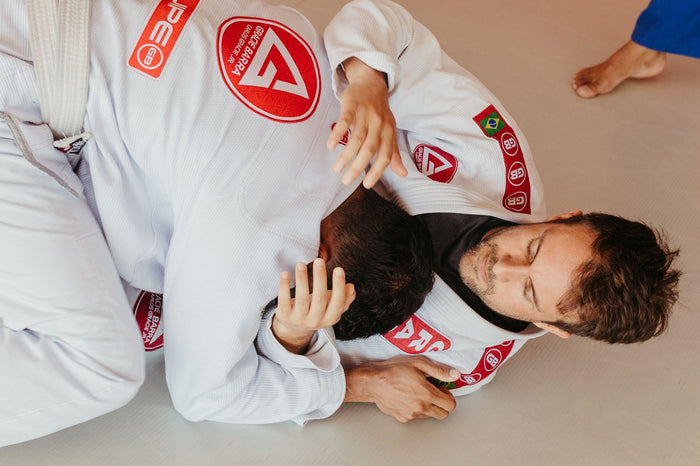 Close gi grappling exchange during BJJ training