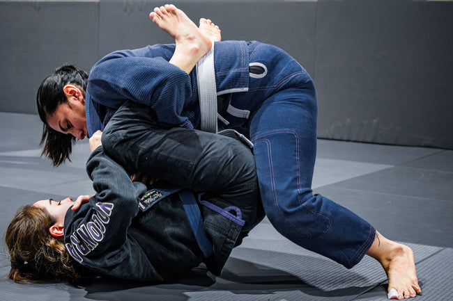 Two women grappling during BJJ training