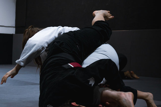 Ground grappling exchange during BJJ training