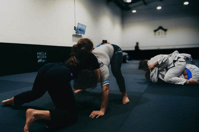 Group of BJJ practitioners drilling technique in a dojo